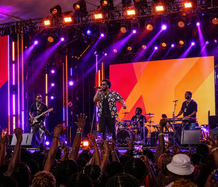 Live band performing on stage inside an aluminum alloy clear span event tent.
