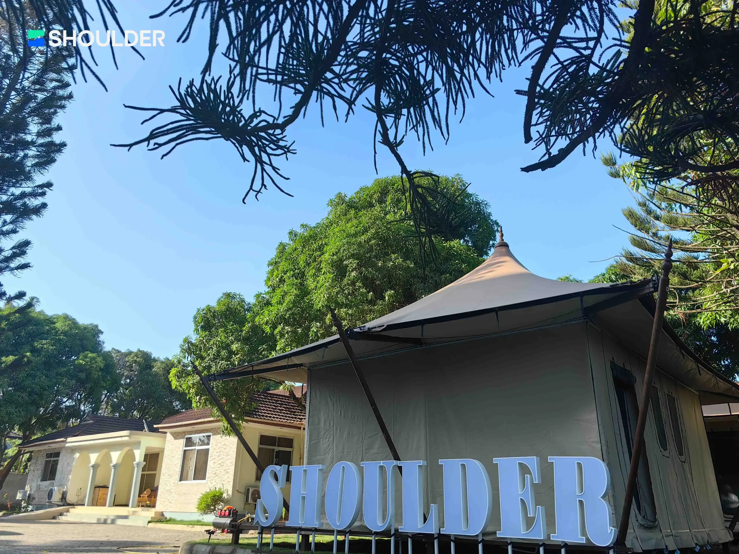 Exterior of Shoulder Tent Africa office featuring a semi-permanent aluminum safari tent.